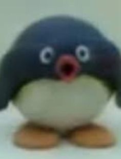 a small stuffed penguin with its mouth open