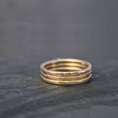 Set of Three 14k gold filled stacking rings. Each ring is hand formed and hammered creating a surface texture to catch the light. Polished to a bright shine. I use durable, high quality 14k gold-fill to make these rings. 14 karat gold-fill has a thick layer of karat gold, not just a microscopic film, as is the case with gold-plated and gold vermeil items.This set of rings will be hand made to order in your size.For more stacking rings:https://www.etsy.com/shop/KiraFerrer/search?search_query=stac Dainty Hand Forged Gold Stackable Rings, Hammered Stackable Rings In Recycled Gold, Hammered Recycled Gold Stackable Rings, Gold Hammered Stackable Rings For Everyday Wear, Everyday Gold Hammered Stackable Rings, Minimalist Hammered Stackable Rings In Recycled Gold, Rings Stack, Set Of Rings, Ring Bands