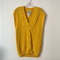 Vintage 80’s Deadstock Millers Outpost Yellow Cable Knit Sweater Vest Size Small * Vest With Cable Knit Along Neckline And Down Center * Larger Size Arm Holes * V-Neck * New With Tag * Some Piling Under Arm. Shown In Photo. Overall Great Condition For The Age. Retro Chunky Knit Fall Sweater, Retro Chunky Knit Sweater For Fall, Casual Yellow Sweater Vest For Winter, Casual One Size Sweater Vest For Fall, Retro Knit Sweater Vest For Spring, Retro Knitted Sweater Vest For Winter, Retro Knit Sweater Vest For Winter, Vintage Sweater Vest For Fall, Retro Knitted Sweater For Spring