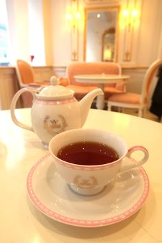 two tea cups and saucers sitting on a table