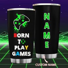 two black cups with green and red designs on them, one has the name born to play games