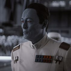 a star wars character with red eyes looking at the camera