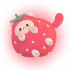 an animal shaped toy with pink and yellow dots on it's body, sitting in the shape of a strawberry