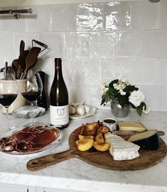 some food and wine on a kitchen counter