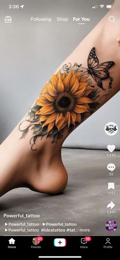 a sunflower tattoo on the side of a woman's leg with butterflies around it