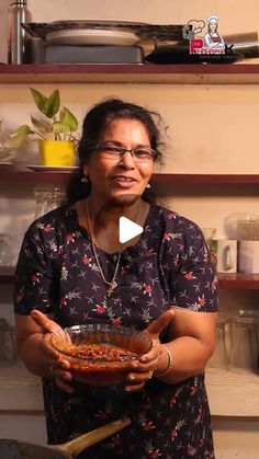 a woman holding a bowl of food in her hands