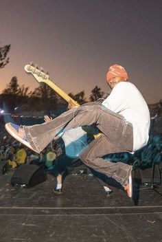 a man jumping in the air with a guitar