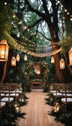 an outdoor ceremony with lights strung from the trees and chairs on the ground, surrounded by greenery