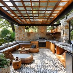 an outdoor kitchen and dining area with stone flooring