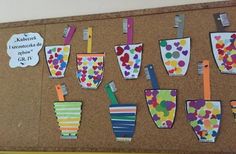 a bulletin board with lots of toothbrushes and paper cups on it's side