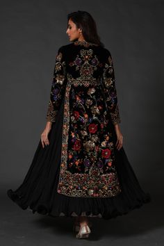 Editor's Note Black Silk Velvet Split Anarkali, Attached Crinkled Ghera Comes With Dupatta & Churidar Color: Black Fabric: Silk Velvet & Cotton Care: Dry Clean Only About the Designer Rohit Bal is intensely concerned with design as an art form. The designer draws on history, fantasy and folklore to create masterpieces that are desired by discerning aficionados around the globe. Rohit has a deep understanding of the psyche of the fashion world and it reflects in his collections that are intellige Velvet Anarkali, Black Anarkali, Long Jackets For Women, Embroidered Anarkali, Velvet Dress Designs, Rohit Bal, Velvet Suit, Dresses Indian, Designer Dresses Indian