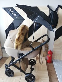 a baby stroller with an umbrella attached to it