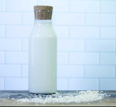 a bottle of milk sitting on top of a wooden table