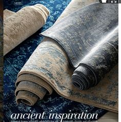 two rolled up rugs sitting on top of a blue and white carpeted floor