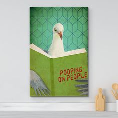 a white bird sitting on top of a green book