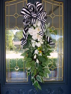 a blue door with a black and white bow on it