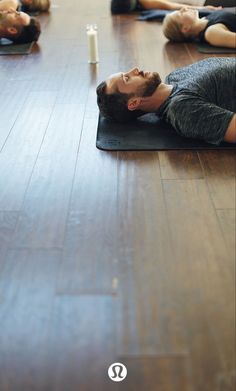 a group of people laying on yoga mats