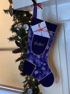 a christmas stocking hanging from the side of a door next to a decorated tree