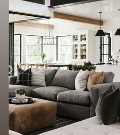 a living room filled with furniture and lots of windows