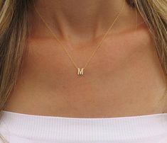 A tiny gold initial necklace is perfect for everything in your wardrobe.  14k gold-filled initial on a delicate 14k gold-filled chain.  It is so cute and perfect for layering with other necklaces.  This necklace can be great for your bridesmaid gifts. 14k Gold-filled Initial measures 6 mm. The necklace on the model measures 16" (choose your length from the menu 15" - 18") This listing is for one initial.  Capital letters only. ♥ Beautiful package ready for gifting Looking for 2 letters necklace: https://www.etsy.com/il-en/listing/656788445/personalized-necklace-with-two-initial?ref=shop_home_active_1 This necklace is available in Sterling Silver: https://www.etsy.com/il-en/listing/572726414/tiny-silver-initial-necklace-uppercase?ref=related-8 View more Personalized Jewelry - https://www.et Initial Necklace Gold Letters, Personalized Gold Jewelry, Letter Necklace Gold, Gold Wrap Ring, Gold Initial Necklace, Gold Letter Necklace, Handmade Gold Jewellery, Packing Jewelry, Initial Necklace Gold