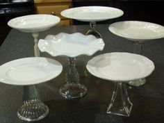 five white plates sitting on top of a black counter