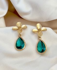 Enhance your elegance with our Green Teardrop Flower Earrings. These dainty and graceful accessories bring a touch of nature's beauty to your ensemble. Delicate gold flowers and a green crystal teardrop make them perfect for any occasion, from casual gatherings to special events. Handcrafted with care, these earrings are a delightful addition to your jewelry collection, offering a unique blend of charm and sophistication." *925 Silver posts * Crystals Gold flower earrings, green bridesmaid earrings, teardrop earrings, boho bridal earrings, whimsical earrings, woodland wedding, wedding gift Elegant Teardrop Earrings With Flower Charm, Green Flower Charm Drop Earrings, Teardrop Flower Charm Jewelry For Wedding, Elegant Green Earrings With Flower Charm, Delicate Teardrop Flower Earrings For Pierced Ears, Delicate Teardrop Flower Earrings, Green Flower Shaped Jewelry For Wedding, Delicate Green Flower Earrings For Wedding, Elegant Green Flower Earrings