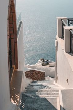 an alley way with steps leading to the ocean