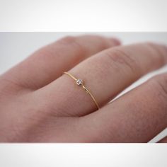 14k Yellow Gold Tiny Diamond Ring, Diamond Ring with thin band, Dainty Diamond Ring, diamond engagement ring, Diamond stack ring, thin  Diamonds : This is a beautiful 1.75mm (.02ct weight) round full facet diamond. The diamond is Bezel set in 14kt yellow gold.  ✦Gemstone: genuine diamond  ✦Stone Cut: round brilliant cut ✦Stone Size: 1.75mm ✦Metal: solid 14K gold .8mm  This band is perfect for stacking, and looks beautiful on its own.  Jenhoughdesigns.etsy.com Fine Rings Simple, Simple Gold Diamond Ring, Engagement Rings Petite, Tiny Diamond Ring, Square Engagement Rings, Yellow Diamond Engagement Ring, Slim Ring, Dainty Diamond Ring, Real Diamond Rings