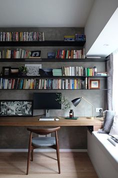 a home office with bookshelves full of books