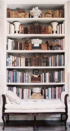 a white book shelf filled with lots of books