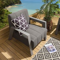 a gray chair sitting on top of a wooden deck