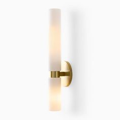 a wall light that is on the side of a white wall with a glass shade