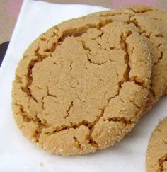 two peanut butter cookies sitting on top of a white napkin