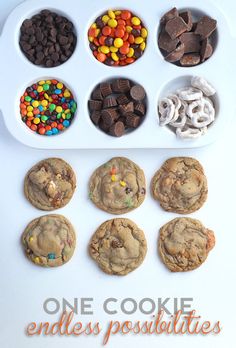 chocolate chip cookies, candy and other treats are arranged in a muffin tray on a white surface