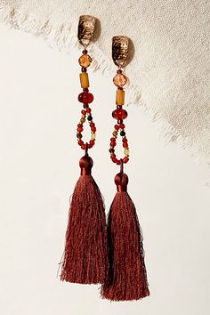 Designed to add a fun and funky touch to absolutely any look, these stunning earrings are featured in a dangly design with tiered beading, hammered metal detailing, and defined fringe tassel at bottom for added dimension. **Features:** Dangle design, post-back closure **Why We ❤ It:** Sure to be a staple in your jewelry collection for countless years to come, these stunning earrings make a statement with any style from something cool and casual to a more formal ‘fit. | Mariposa Dangle Earrings b Popular Earrings, Free People Jewelry, Chic Earrings, Animal Rings, Hammered Metal, Bohemian Necklace, Tassel Fringe, Tigers Eye, Stunning Earrings