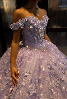 a woman in a purple dress with flowers on it