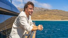 a man standing on the deck of a boat