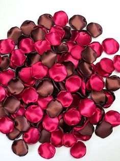 a pile of pink and brown hearts on a white surface