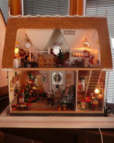 a doll house with all the furniture and decorations on display in front of a window