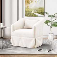 a white chair sitting on top of a wooden floor next to a potted plant