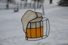 a stained glass beer mug hanging from a chain