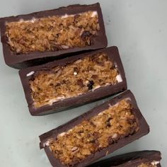 four pieces of chocolate with granola toppings on them