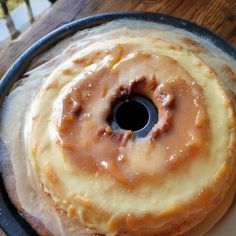 a bundt cake with icing and nuts on it sitting on a pan ready to be baked