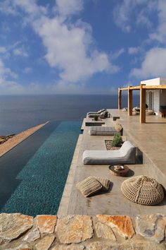 an outdoor lounge area next to the ocean