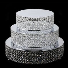 three tiered cake stand with lots of diamonds on the top and bottom, all stacked together