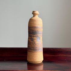 a vase sitting on top of a wooden table