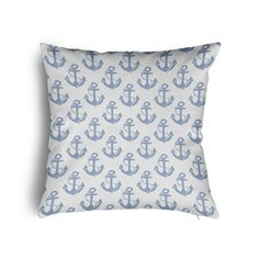 a blue and white pillow with an anchor pattern on the front, sitting on a white background