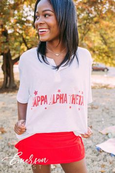 "Looking for a trendy sorority tshirt that'll last? 🫶🏻 This Kappa Alpha Theta Simple Hearts Henley is the answer! Whether you're giving this tee as a gift or treating yourself with something new, you'll be obsessed with this sorority t-shirt! 🌊 YOU'LL LOVE THIS STYLE 🌊 Meet the Kappa Alpha Theta Simple Hearts Henley - a classic sorority tee! This heather white henley features three buttons, perfect for layering your favorite necklaces. The lightweight, breathable fabric is as comfy as an ove White Short Sleeve Sorority Top, Sorority Relaxed Fit Graphic Print Tops, Sorority Style Relaxed Fit Graphic Print Tops, White Sorority Tops With Letter Print, Sorority Short Sleeve Tops With Letter Print, Sorority Letter Print Short Sleeve Tops, Sorority Style Letter Print Tops For College, Sorority Letter Print Tops For College, Sorority Graphic Print Tops For College