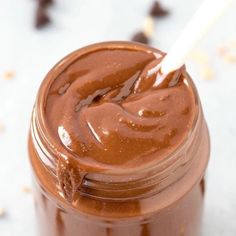 a jar filled with chocolate spread and a spoon