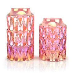 two pink vases sitting next to each other